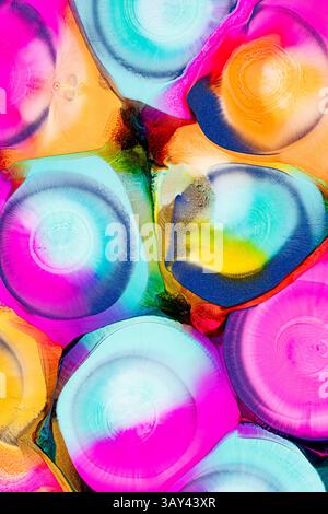 An array of vibrant, abstract ink patterns featuring a mixture of bright pink, turquoise, orange, yellow, and black colors spread artistically across Stock Photo
