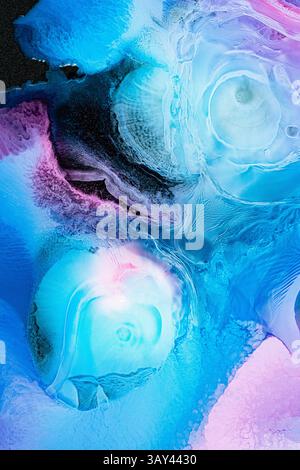 A stunning abstract composition featuring galactic patterns of blue and purple hues. This fluid watercolor art evokes a sense of movement in the galax Stock Photo