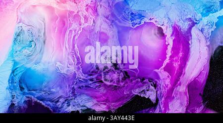 This abstract artwork displays a stunning blend of blue, pink, and purple hues, creating a liquids, dreamy texture reminiscent of a galactic landscape Stock Photo