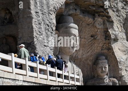 (250422) -- DATONG, April 22, 2025 (Xinhua) -- Tourists visit Yungang Grottoes in Datong, north China's Shanxi Province, April 15, 2025. Yungang Grottoes was built during the Northern Wei Dynasty (386-534). It is considered a pinnacle of Chinese Buddhist art and represents the highest level of sculptural artistry in the world during the 5th century. In recent years, Shanxi has made great efforts to protect and study the grottoes. In 2021, the research institute of the Yungang Grottoes was established for the protection, research and management of the Yungang Grottoes. Since 2003, the UNESC Stock Photo