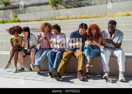Multiethnic group of young friends meeting and having fun outdoors - Multiracial happy and stylish teen students bonding in the city, concepts about y Stock Photo