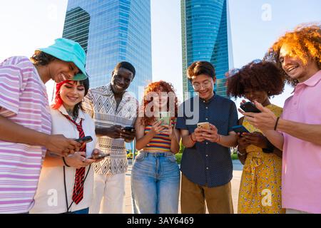 Multiethnic group of young friends meeting and having fun outdoors - Multiracial happy and stylish teen students bonding in the city, concepts about y Stock Photo