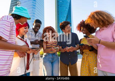 Multiethnic group of young friends meeting and having fun outdoors - Multiracial happy and stylish teen students bonding in the city, concepts about y Stock Photo