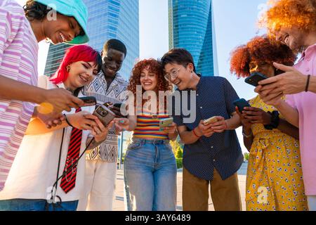 Multiethnic group of young friends meeting and having fun outdoors - Multiracial happy and stylish teen students bonding in the city, concepts about y Stock Photo