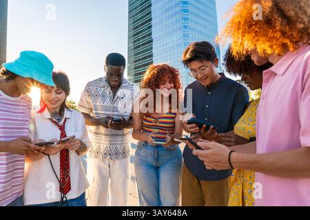 Multiethnic group of young friends meeting and having fun outdoors - Multiracial happy and stylish teen students bonding in the city, concepts about y Stock Photo