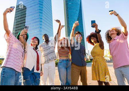 Multiethnic group of young friends meeting and having fun outdoors - Multiracial happy and stylish teen students bonding in the city, concepts about y Stock Photo