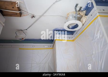 Stretch ceiling Installation in Progress in Bathroom. Stock Photo