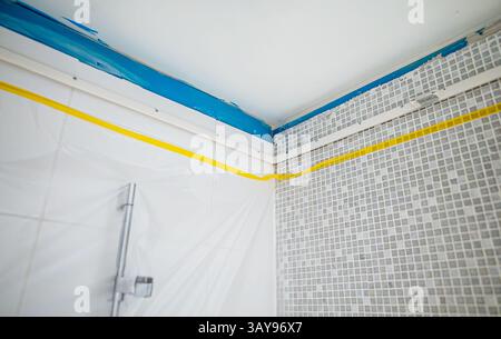 Stretch ceiling Installation in Progress in Bathroom. Stock Photo