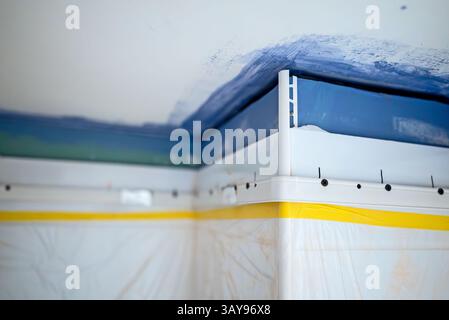 Stretch ceiling Installation in Progress in Bathroom. Stock Photo