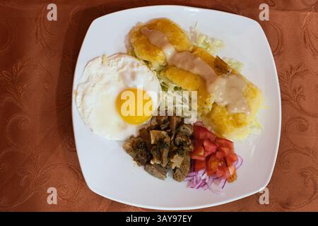 An incredibly hearty breakfast plate featuring delectable eggs, savory sides, and an array of fresh toppings Stock Photo
