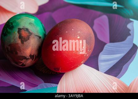 Colorful artistic Easter eggs resting on a vivid backdrop, symbolizing spring celebration. Stock Photo