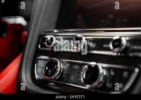 Close Up of Control Panel in Luxury Car with Red Leather Interior Stock Photo