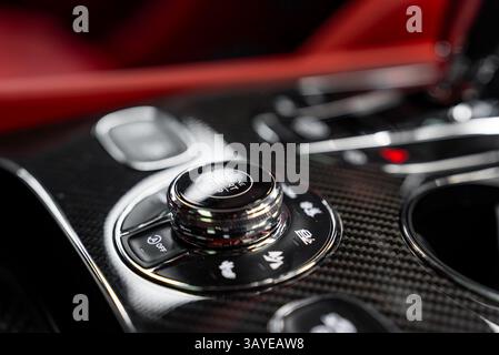 Close Up of Carbon Fiber Console with Rotary Control in Luxury Car Stock Photo