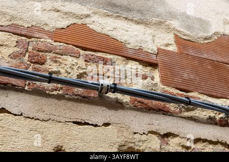 Exposed Brick Wall with Cable Installation Stock Photo
