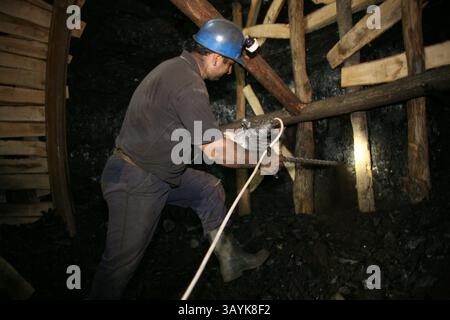 Jan 13, 2007 - Burgas, Brazil - A laborer drills into the walls of the mine. There are several undergound coal mines in Bulgaria still operating. The coal is used to generate electricity. Working conditions are hard in the mines, which can descend to 700 meters underground. The environment is dangerous since safety regulations are not taken very seriously. Many of the miners die before age 50 due to lung disease. Date is approximate. (Credit Image: © Ton Koene/ZUMApress.com) Stock Photo
