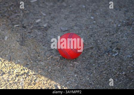 red baseball with navy stitching Stock Photo