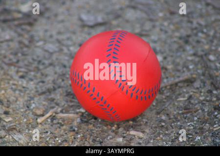 red baseball with navy stitching Stock Photo