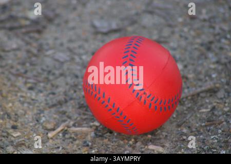 red baseball with navy stitching Stock Photo