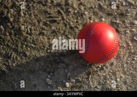red baseball with navy stitching Stock Photo
