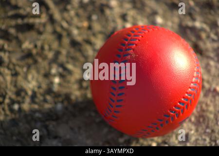 red baseball with navy stitching Stock Photo