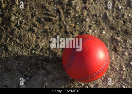 red baseball with navy stitching Stock Photo