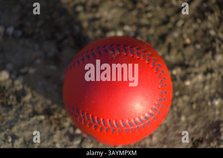 red baseball with navy stitching Stock Photo
