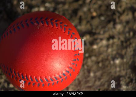 red baseball with navy stitching Stock Photo