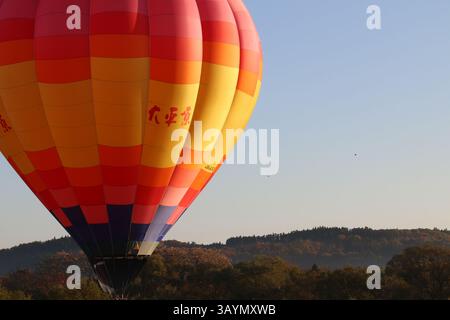 Many colorful balloons float through the air at the annual hot air balloon festival in Osaki, Japan. Stock Photo