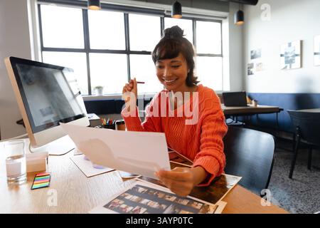 Young Man Using Tablet Man sitting at a wooden desk holding a puppy inside a small floating ...
