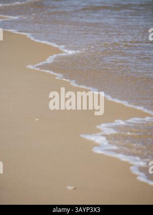 Faro, Algarve, Portugal, close-up of small waves hitting the shore of a sandy beach, Europe Stock Photo