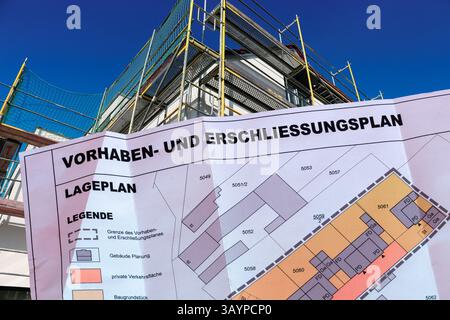 (Photomontage) Close-up of a project and development plan in front of a still converted new building Stock Photo