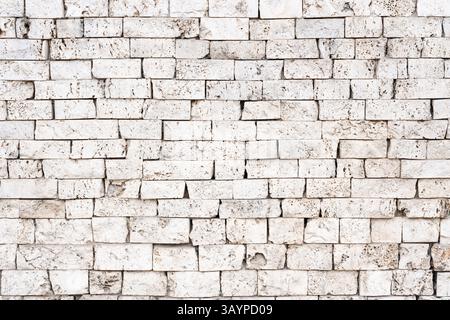 Wall texture or background with exposed bright stones, showcasing traditional craftsmanship. Perfect for architectural, historical, and texture design Stock Photo