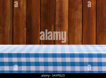 Empty blue and white checkered tablecloth on old wooden background Stock Photo