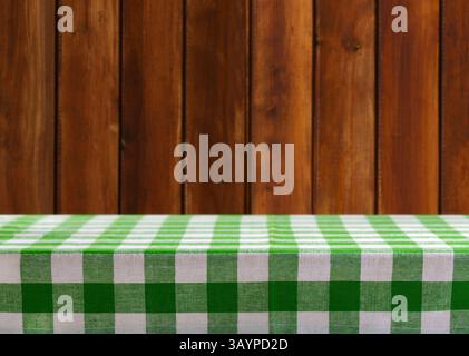 Empty green and white checkered tablecloth on old wooden background Stock Photo
