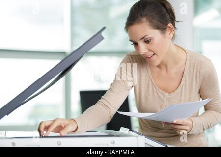 a lady using a photocopier Stock Photo