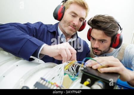 technicians maintaining record of rack mounted server Stock Photo