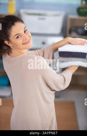 young woman holding clean laundry Stock Photo