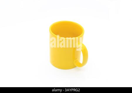 Bright yellow ceramic cup with handle isolated on white background Stock Photo