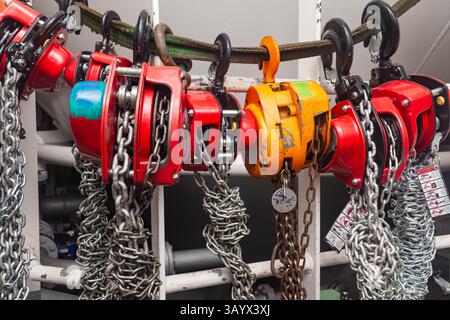 Chain hoists for lifting weights in a workshop close-up. Stock Photo