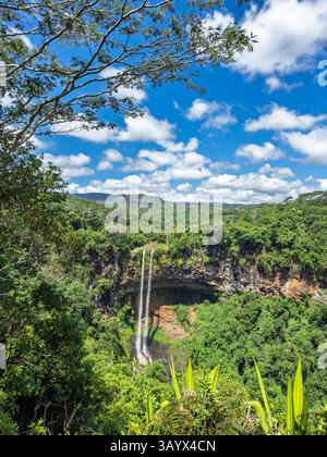 Majestic Waterfall in Lush Valley. Breathtaking Waterfall Amidst Green Mountains  Stock Photo