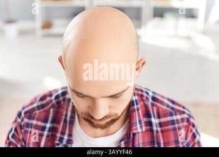 Top view portrait of a young bearded man wearing casual clothes with a bald head close up. Stock Photo