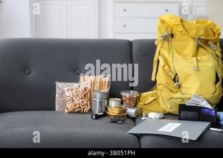 Survival kit. Different emergency supplies on sofa indoors Stock Photo
