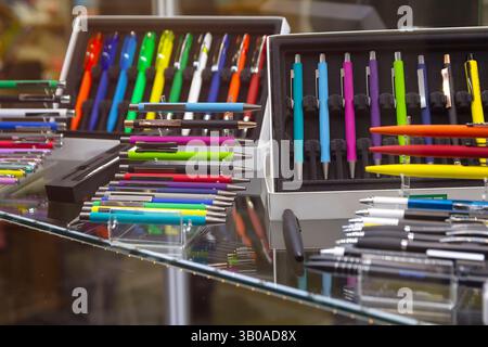 Modern colored plastic ballpoint pens on store display. Sale Stock Photo