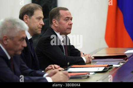 Moscow, Russia. 23rd Apr, 2025. Russian Deputy head of Russia's Security Council Dmitry Medvedev, right, alongside Russian First Deputy Prime Minister Denis Manturov, center, and Interior Minister Vladimir Kolokoltsev, left, before the start of a meeting of the Military-Industrial Commission chaired by President Vladimir Putin, at the Kremlin, April 23, 2025 in Moscow, Russia. Credit: Gavriil Grigorov/Kremlin Pool/Alamy Live News Stock Photo