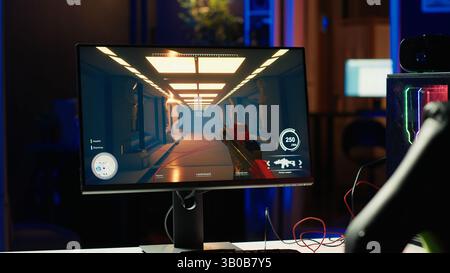 Shooting videogame on PC with neon lights illuminated components in empty apartment. Science fiction game on desktop PC monitor next to virtual reality glasses and computer peripherals Stock Photo