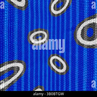 A vibrant blue background is adorned with abstract patterns featuring oval shapes outlined in white and filled with dark gray, creating a playful and dynamic visual effect., A vibrant blue background features a playful pattern of oval shapes outlined in black, creating a lively and dynamic visual effect. Classic art with a modern twist reimagined by Artotop, Transformed French Fabrics, First Half of the Nineteenth Century, Classic art with a modern twist reimagined by Artotop Stock Photo