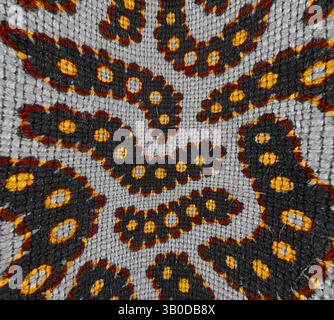 A detailed textile design showcasing a swirling pattern of bold black and orange shapes, interspersed with bright yellow circles, creating a rhythmic and dynamic visual texture., A circular pattern featuring wavy lines and dot designs in shades of orange and black against a gray background. The intricate arrangement creates an eye-catching, lively texture. Classic art with a modern twist reimagined by Artotop, Transformed French Fabrics, First Half of the Nineteenth Century, Classic art with a modern twist reimagined by Artotop Stock Photo