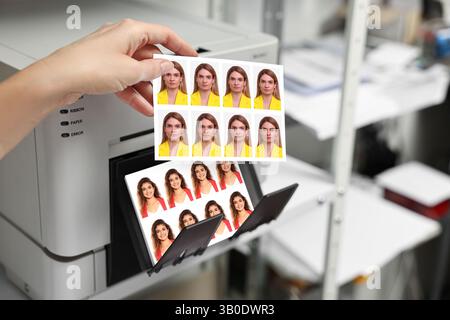 Worker with passport photos of women near modern printer indoors, closeup Stock Photo