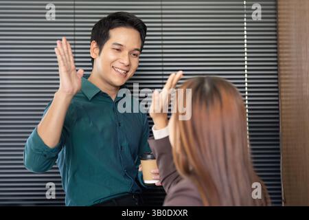 Business Interaction and Professional Networking. A friendly greeting between colleagues in an office setting. Stock Photo