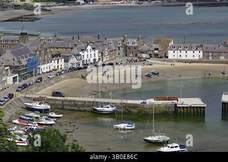 Small harbour with boats and surrounding houses on the coast, relaxed atmosphere, Stonehaven, Scotland, United Kingdom, Europe Stock Photo